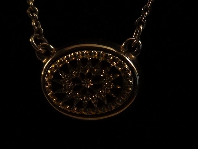 Avon Vintage Signed Necklace in Gold Tone with Black Glass Starburst.  Intricate Detail.  16" Chain.