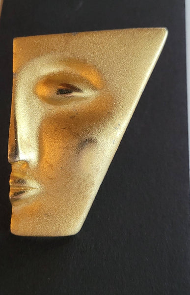 Faces Collection Brooch "My Better Half " is done on Soft Brushed Gold with Polished  Highlights  Features A Senual Sleek Sophisticated Face